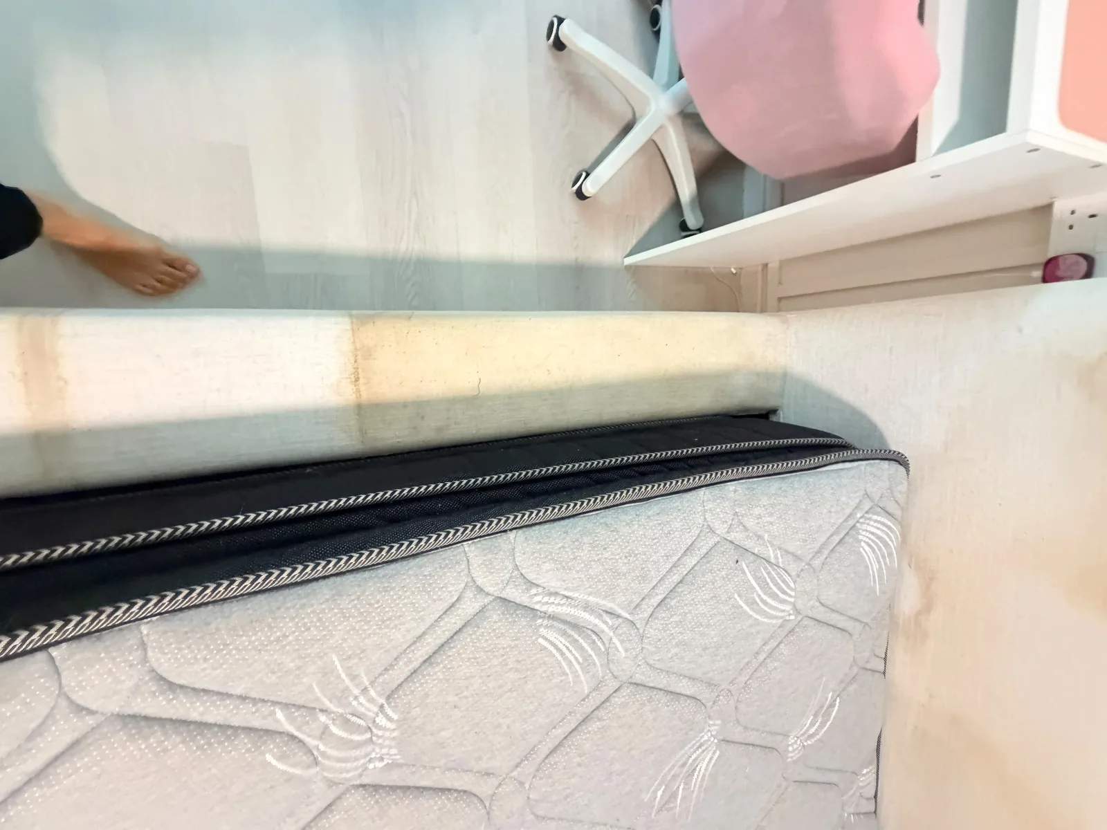 Mattress before deep cleaning — visible staining along the edge