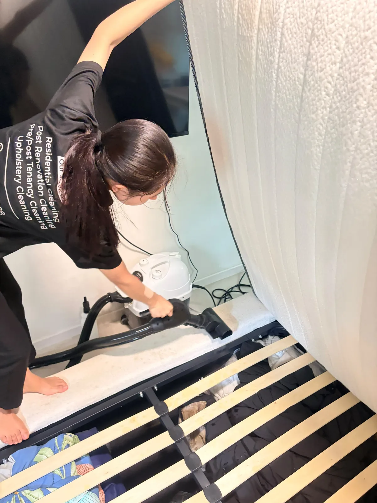Mattress deep cleaning — bed base vacuumed with mattress lifted