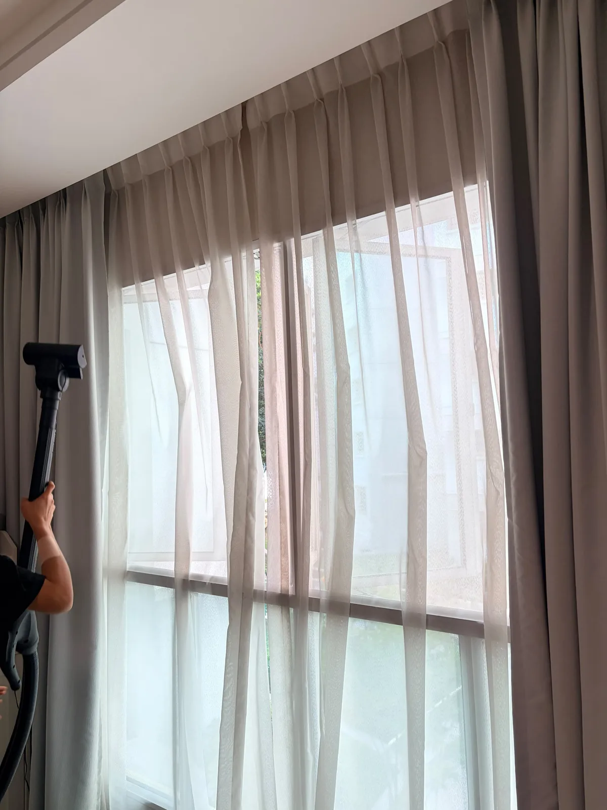 Curtain deep cleaning in progress — full-length extraction treatment