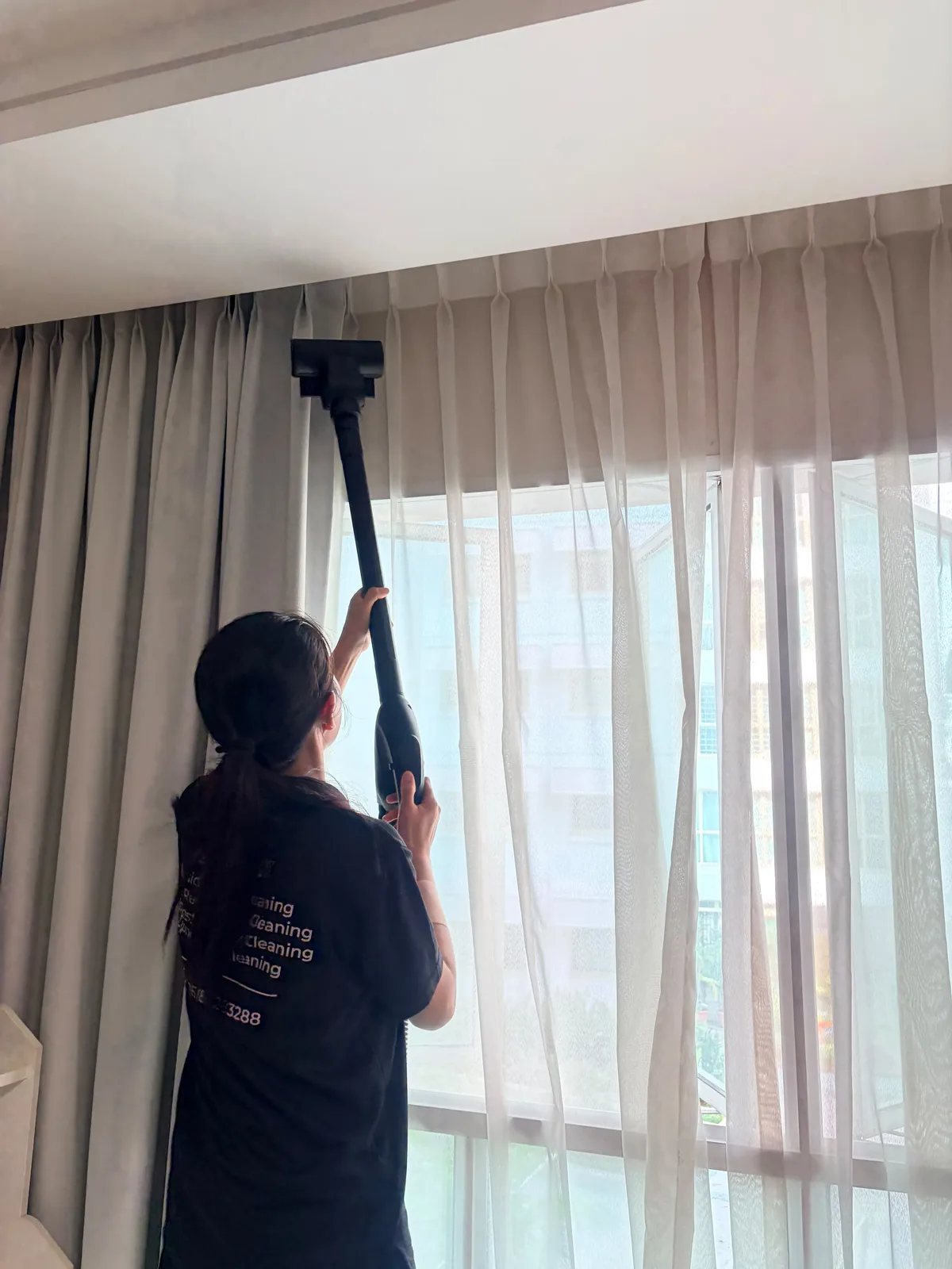 Curtain deep cleaning — upper section treated with extraction tool