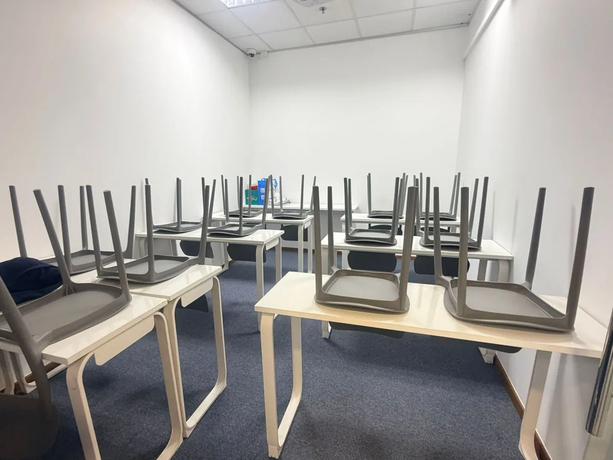 Office cleaning preparation โ chairs stacked for thorough floor access