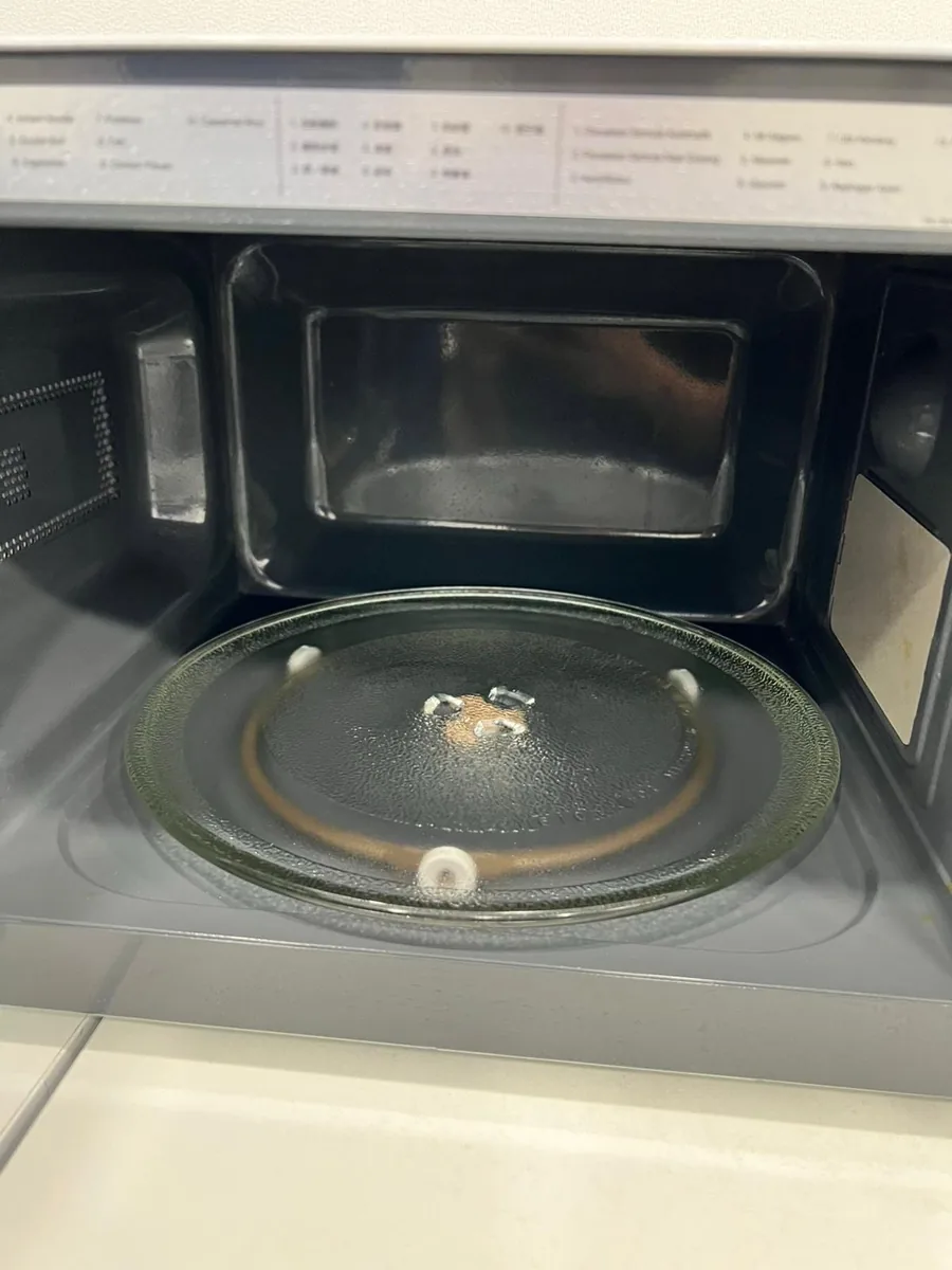Office microwave before cleaning โ grease and buildup inside