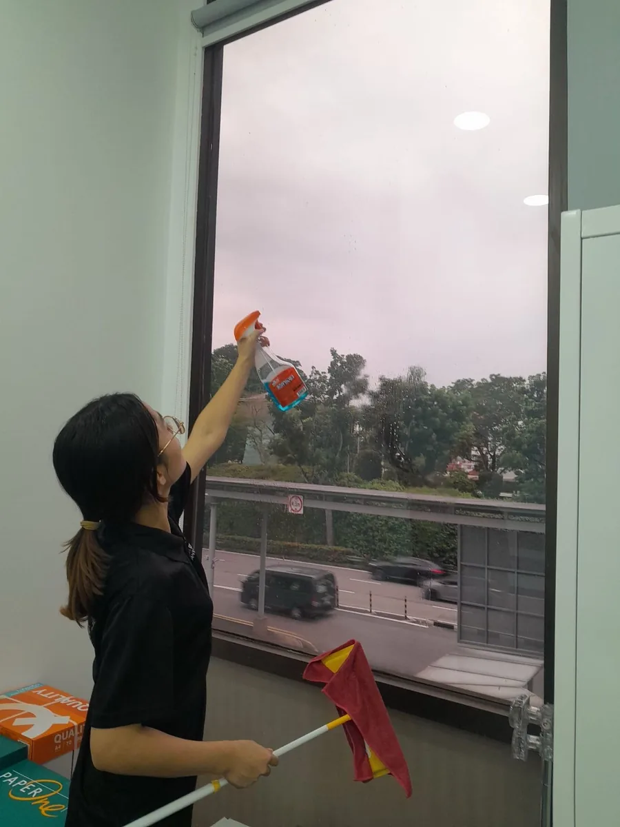 Office window cleaning โ spraying and wiping glass panels