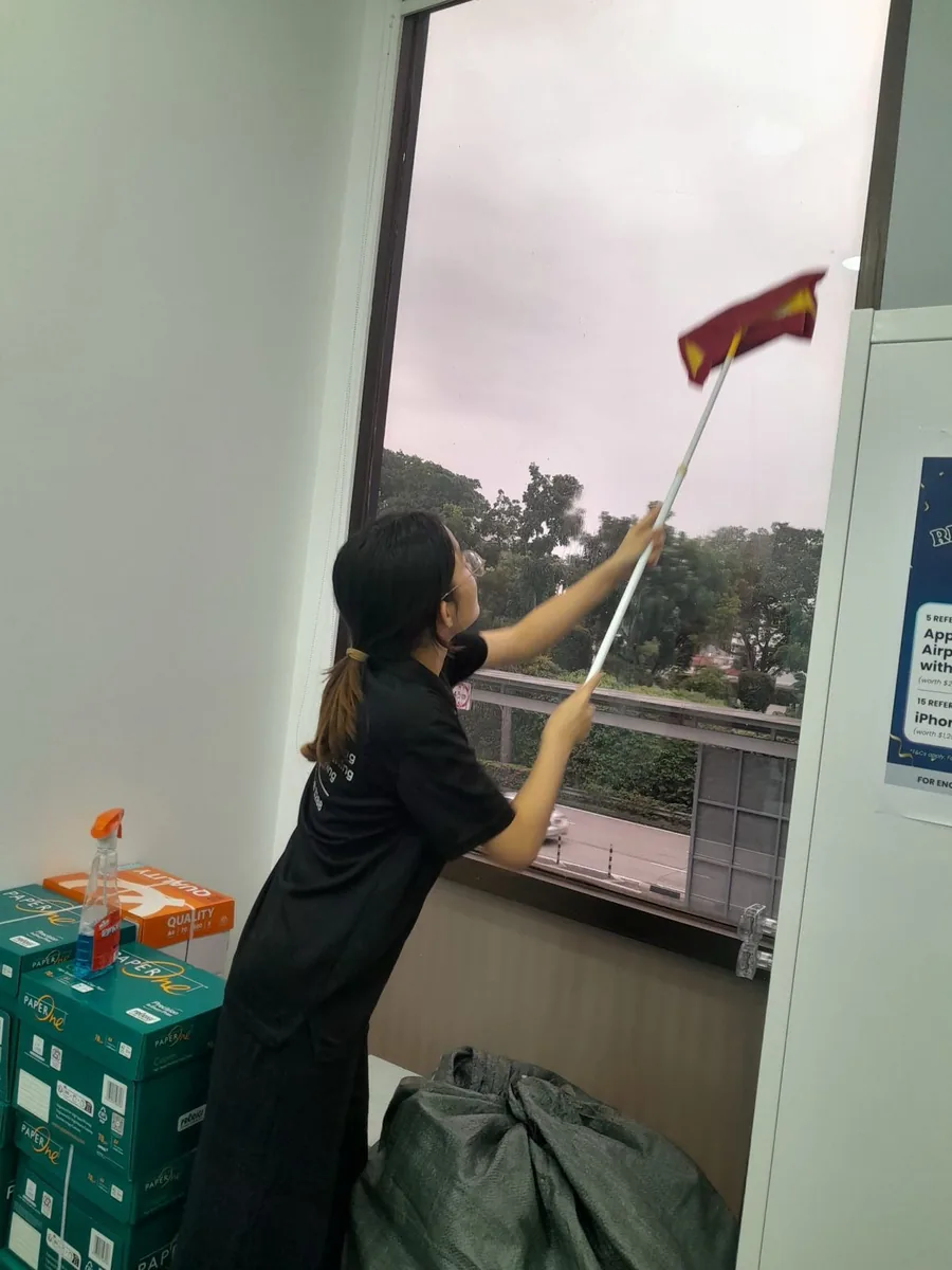 High office window cleaning with long pole โ reaching every pane