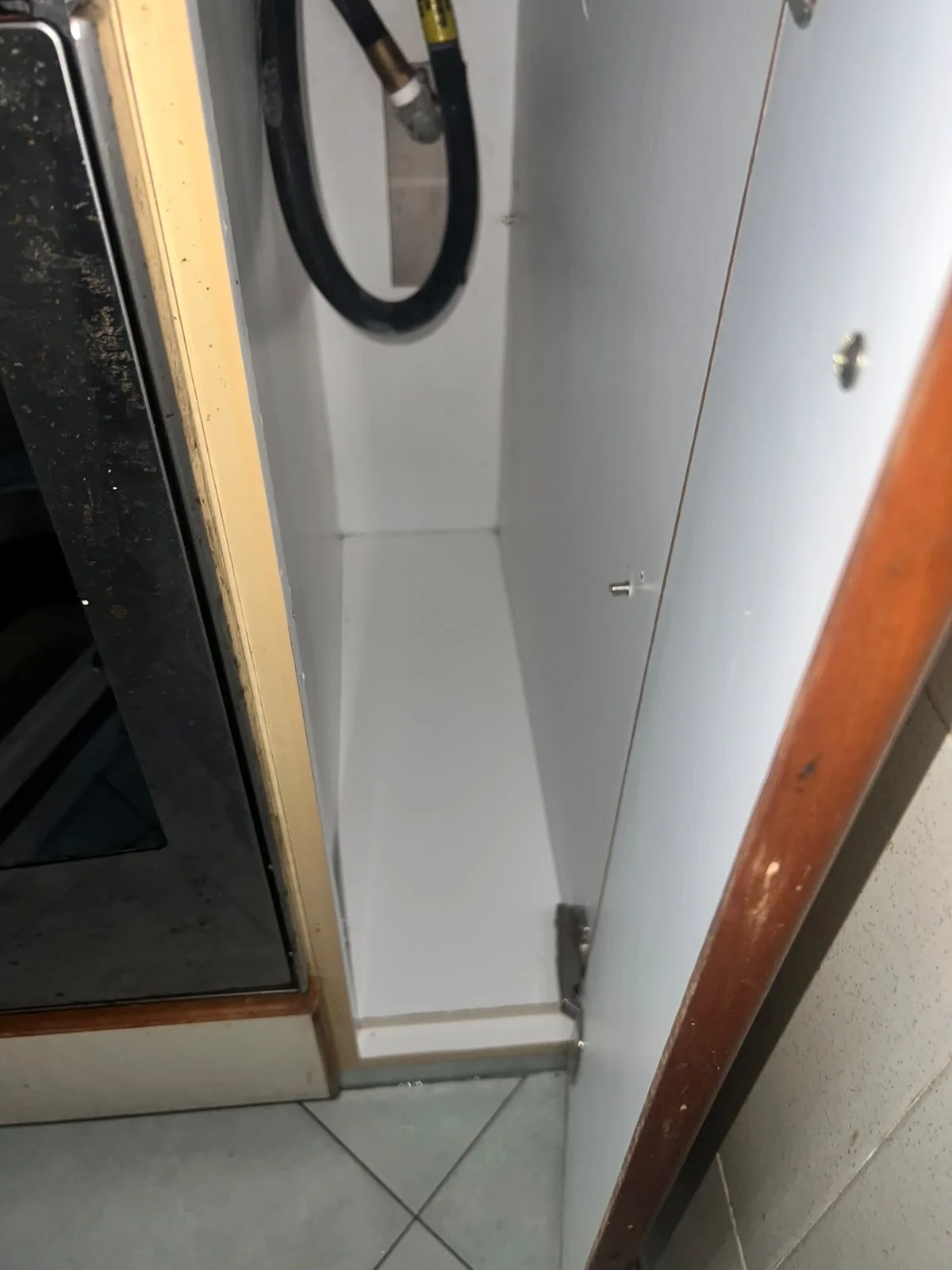 Post-tenancy after cleaning โ narrow kitchen cabinet wiped clean