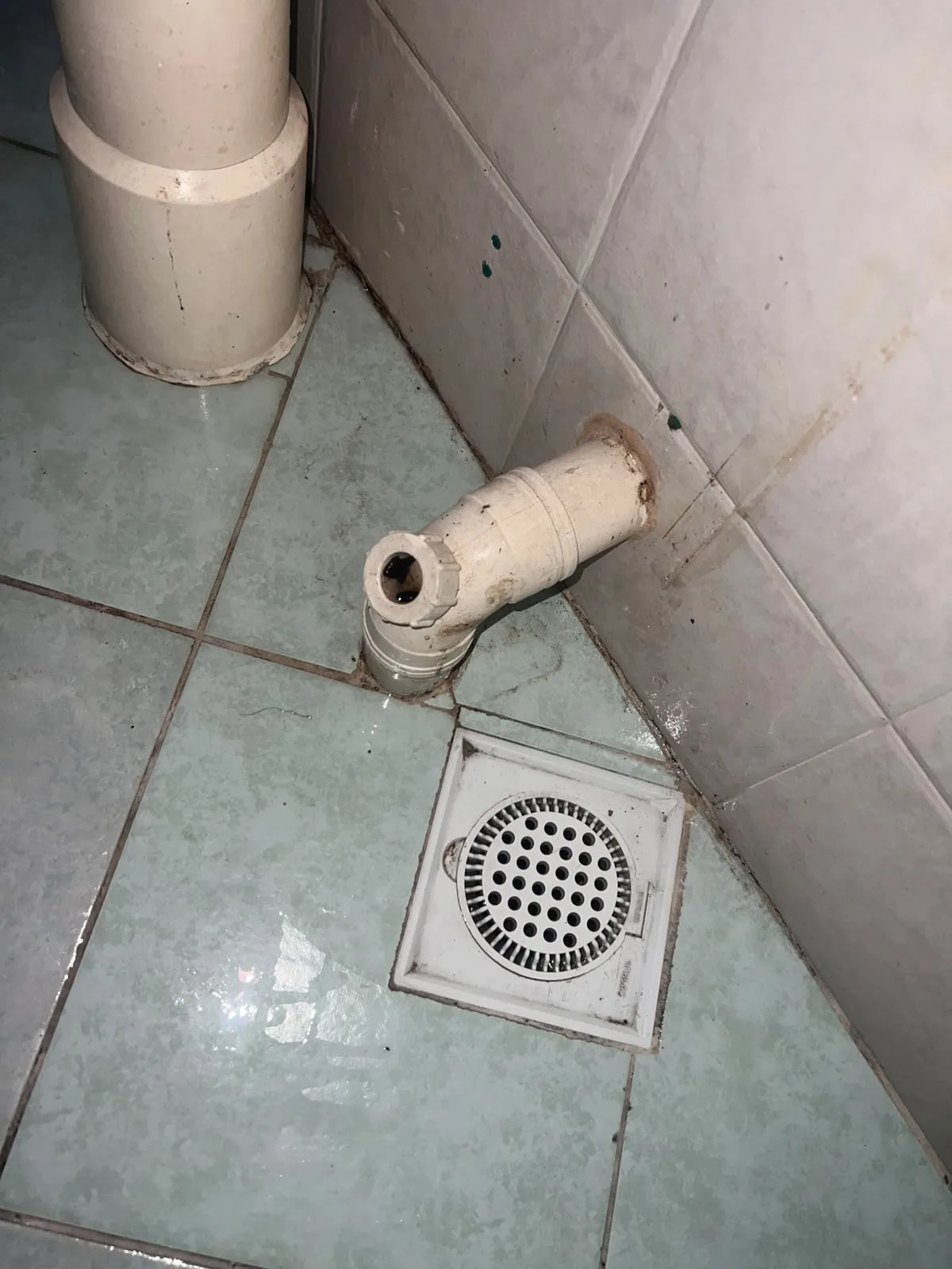 Post-tenancy after cleaning โ bathroom floor and drain area scrubbed clean