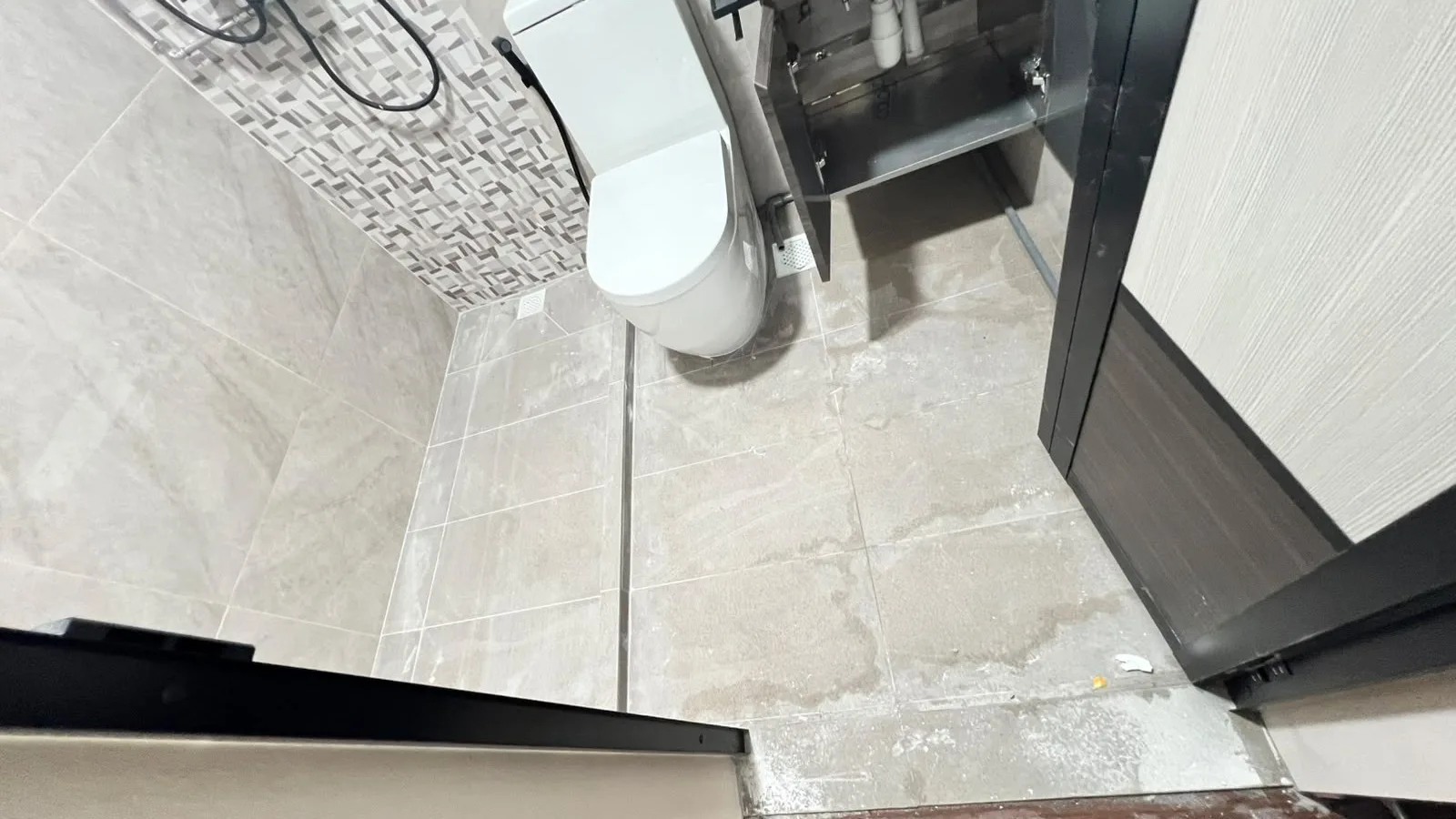 Bathroom before post-reno cleaning โ cement and grout residue