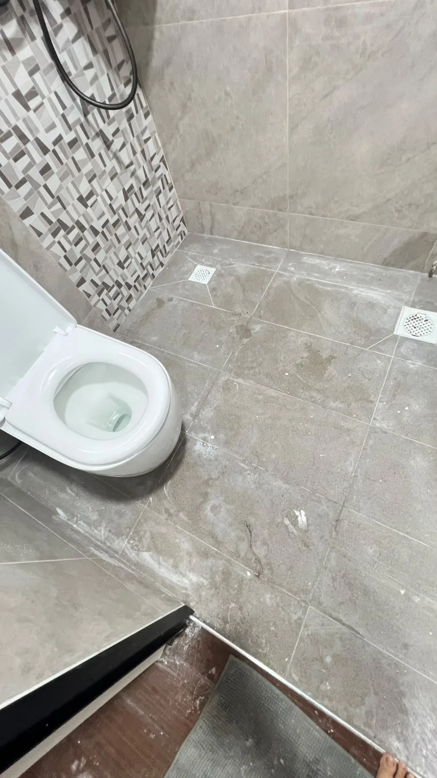 Bathroom before cleaning โ tile haze and debris