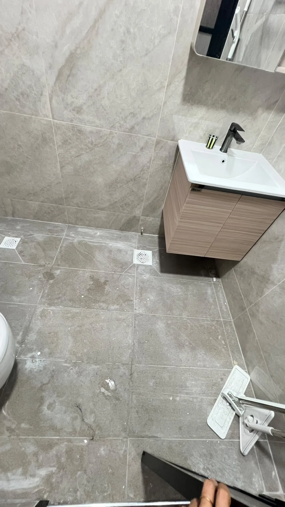 Bathroom before cleaning โ post-renovation residue throughout