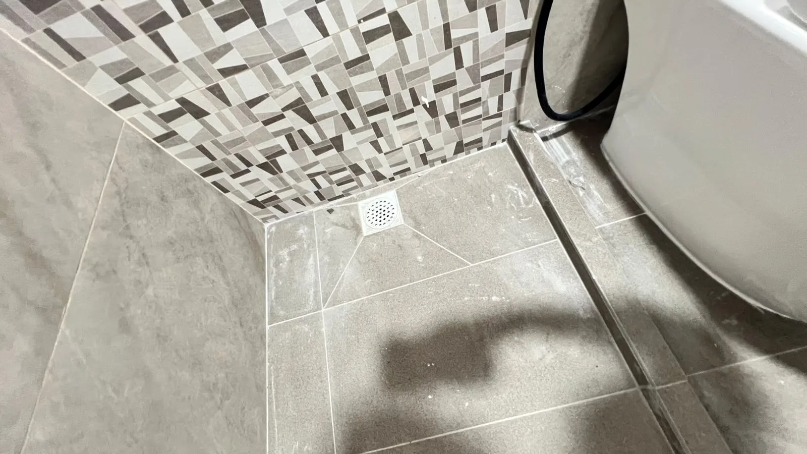 Bathroom before cleaning โ fixtures coated in renovation dust