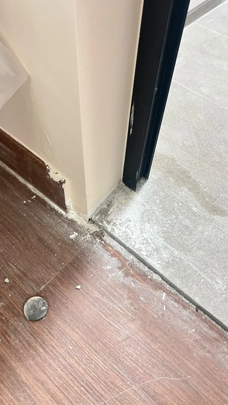 Flooring before post-reno cleaning โ tile haze and cement residue