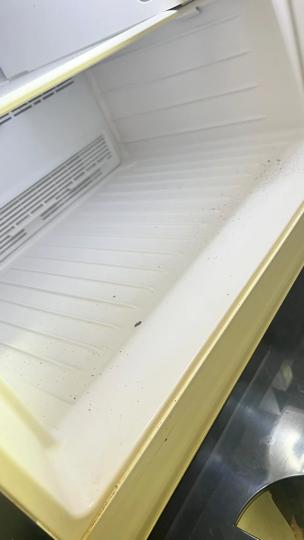 Fridge area before post-reno cleaning โ dust buildup
